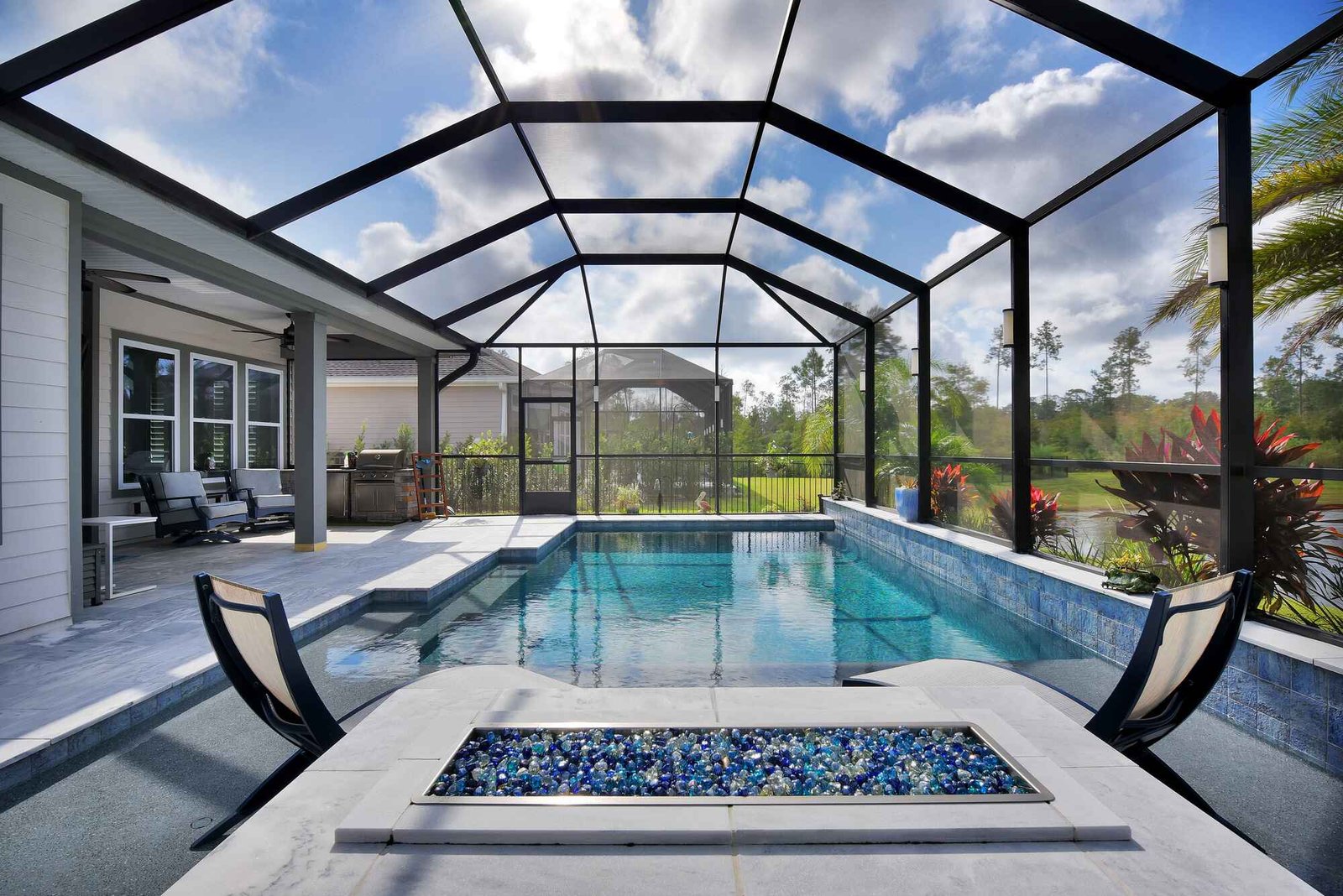 Large pool enclosure installation in Sebring, FL protecting modern residential swimming pool